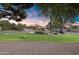 Landscaped backyard with putting green at sunset at 7032 E Dreyfus Ave, Scottsdale, AZ 85254