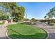 Expansive grassy backyard with putting green and trees at 7032 E Dreyfus Ave, Scottsdale, AZ 85254