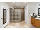 Bathroom with walk-in shower with glass block wall and tile flooring at 7032 E Dreyfus Ave, Scottsdale, AZ 85254