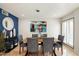 Elegant dining room with a modern chandelier and large windows at 7032 E Dreyfus Ave, Scottsdale, AZ 85254