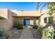 Inviting entryway with a blue front door and neatly landscaped surroundings at 7032 E Dreyfus Ave, Scottsdale, AZ 85254