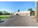 Large home with a three-car garage and paved driveway at 7032 E Dreyfus Ave, Scottsdale, AZ 85254