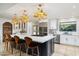 Modern kitchen with large island, stainless steel appliances, and custom cabinetry at 7032 E Dreyfus Ave, Scottsdale, AZ 85254