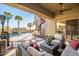 Covered patio with comfortable seating overlooking the pool and spiral staircase at 8497 E Montello Rd, Scottsdale, AZ 85266