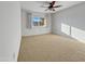 Bright bedroom with carpet flooring and large window at 9209 N 102Nd Dr, Sun City, AZ 85351