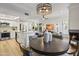 Open concept dining area with a round table and modern lighting at 9705 E Mountain View Rd # 1058, Scottsdale, AZ 85258