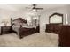 Main bedroom with dark wood furniture and ceiling fan at 10814 W Thunderbird Blvd, Sun City, AZ 85351