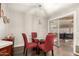 Cozy dining area with glass table and red chairs near patio at 10814 W Thunderbird Blvd, Sun City, AZ 85351