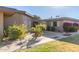 Tan mid-century modern home with landscaped front yard and walkway at 10814 W Thunderbird Blvd, Sun City, AZ 85351