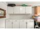 Garage with white cabinets and ample storage space at 10814 W Thunderbird Blvd, Sun City, AZ 85351