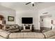 Living room with sectional sofa, fireplace, and large TV at 10814 W Thunderbird Blvd, Sun City, AZ 85351