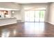 Living room with wood floors and sliding glass doors leading to the backyard and open to the kitchen at 10814 W Thunderbird Blvd, Sun City, AZ 85351
