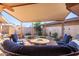 Relaxing covered patio with seating area and fire pit at 10814 W Thunderbird Blvd, Sun City, AZ 85351