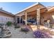 Covered patio with seating area, grill, and water feature at 10814 W Thunderbird Blvd, Sun City, AZ 85351