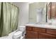 Bathroom with wood vanity, granite countertop, and bathtub shower combo at 10855 E Elba Way, Scottsdale, AZ 85262