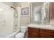 Updated bathroom with wood vanity, granite countertop, and shower at 10855 E Elba Way, Scottsdale, AZ 85262