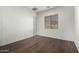 Bright bedroom featuring dark laminate wood flooring and window blinds at 10855 E Elba Way, Scottsdale, AZ 85262