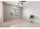 Bedroom with tile floors, window, and ceiling fan at 10855 E Elba Way, Scottsdale, AZ 85262