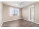 Bedroom with wood-look floors, window, and ceiling fan at 10855 E Elba Way, Scottsdale, AZ 85262