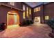 Courtyard entry with tile flooring, arched entryway, and large planters at 10855 E Elba Way, Scottsdale, AZ 85262