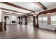 Spacious dining room with hardwood floors, wood beams, and a fireplace at 10855 E Elba Way, Scottsdale, AZ 85262