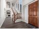 Grand entryway with a wooden staircase and dark hardwood floors at 10855 E Elba Way, Scottsdale, AZ 85262