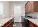 Laundry room with granite countertops and built-in cabinets at 10855 E Elba Way, Scottsdale, AZ 85262