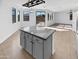 Kitchen island with granite countertop overlooks Gathering room and pool at 12037 W Via Del Sol Ct, Sun City, AZ 85373