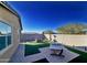 Relaxing backyard with artificial turf and a fire pit at 12668 W Orangewood Ave, Glendale, AZ 85307