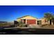 House exterior featuring a red garage door and light yellow walls at 12668 W Orangewood Ave, Glendale, AZ 85307