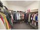 Large walk-in closet with ample shelving and hanging space at 12668 W Orangewood Ave, Glendale, AZ 85307