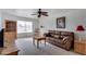 Living room with brown leather couch and wood furniture at 13232 N 98Th Ave # N, Sun City, AZ 85351