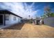 Wide backyard with block wall and partial view of the house at 1410 E Bishop Dr, Tempe, AZ 85282