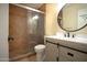 Bathroom with a sliding glass door shower, round mirror, and modern vanity at 1410 E Bishop Dr, Tempe, AZ 85282