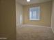 Bedroom view shows neutral carpet and one window at 1410 E Bishop Dr, Tempe, AZ 85282