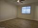 This bedroom has a ceiling fan, window with blinds, and wood flooring at 1410 E Bishop Dr, Tempe, AZ 85282