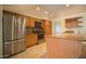 Well-lit kitchen featuring stainless steel appliances and a granite countertop island at 1410 E Bishop Dr, Tempe, AZ 85282