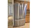 Stainless steel refrigerator complementing the wooden cabinets and countertops at 1410 E Bishop Dr, Tempe, AZ 85282