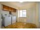 Bright laundry room with white appliances and storage cabinets at 1410 E Bishop Dr, Tempe, AZ 85282