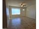 Bright living room features neutral walls, tile flooring, and a ceiling fan at 1410 E Bishop Dr, Tempe, AZ 85282