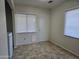 This mud room has tile flooring, a door, and window with blinds at 1410 E Bishop Dr, Tempe, AZ 85282