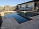 Backyard pool with basketball hoop in secured fenced in area with patio steps for easy pool access at 1410 E Bishop Dr, Tempe, AZ 85282