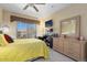 Bedroom with yellow bedding and ceiling fan at 14950 W Mountain View Blvd # 4305, Surprise, AZ 85374