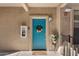 Teal front door with wreath and potted plants at 14950 W Mountain View Blvd # 4305, Surprise, AZ 85374