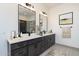 Elegant bathroom with double vanity and large mirror at 15385 W Bajada Dr, Surprise, AZ 85387