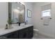 Modern bathroom with dark vanity and a walk-in shower at 15385 W Bajada Dr, Surprise, AZ 85387