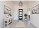 Bright and airy entryway with modern light fixture and console table at 15385 W Bajada Dr, Surprise, AZ 85387