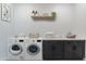 Laundry room with side-by-side washer and dryer and storage at 15385 W Bajada Dr, Surprise, AZ 85387