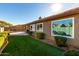 Landscaped backyard with artificial turf and a view of the home's exterior at 15415 S 37Th Pl, Phoenix, AZ 85044