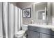 Modern bathroom with gray vanity and striped shower curtain at 15415 S 37Th Pl, Phoenix, AZ 85044